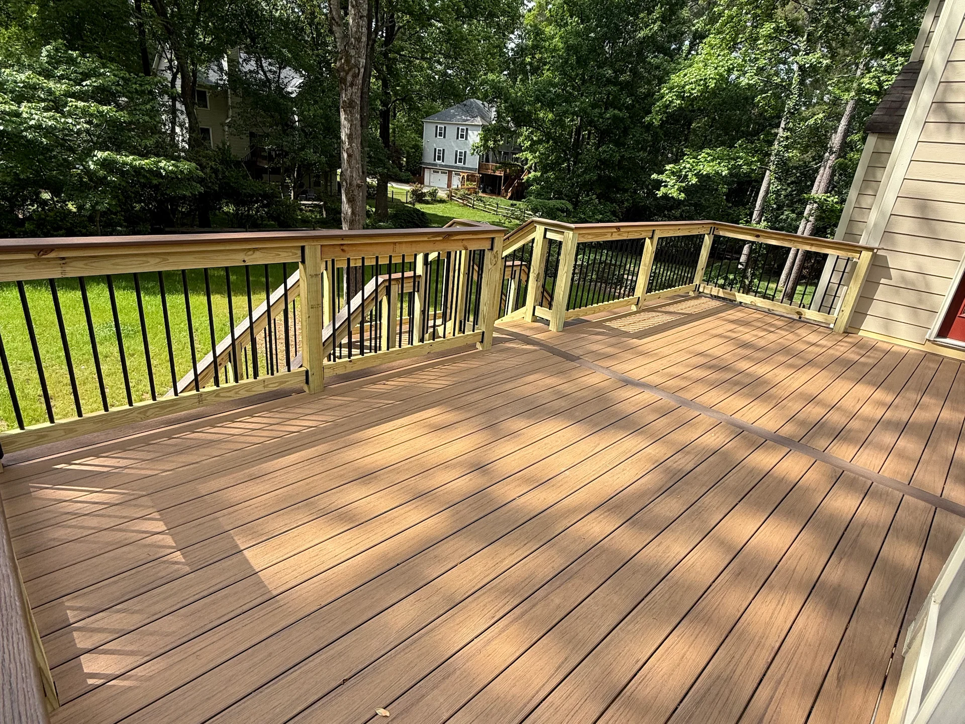Composite deck with wood railing